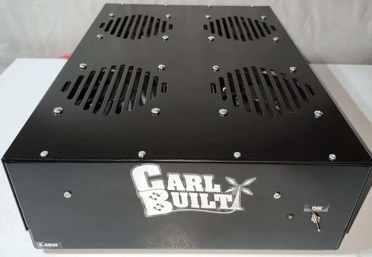 A black metal box with four vents on top.